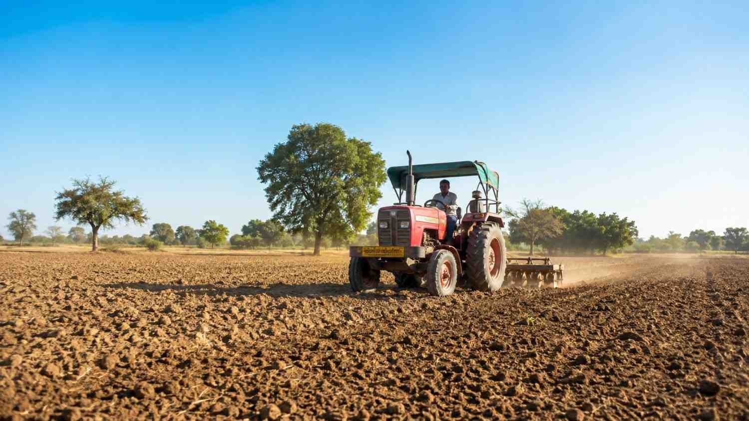 Farmer preparing field for green gram cultivation with tractor